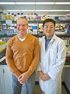 Two researchers stand in a lab.